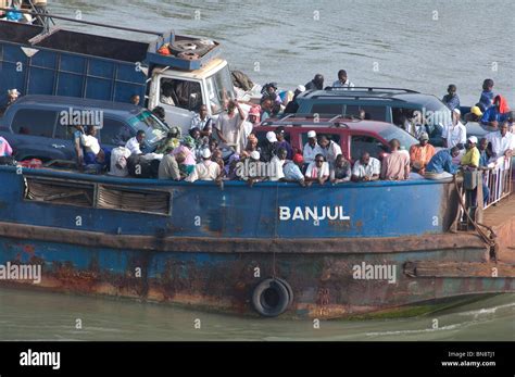 Africa, Gambia. Capital city of Banjul. Port area of Banjul. Over crowded passenger & car ferry ...