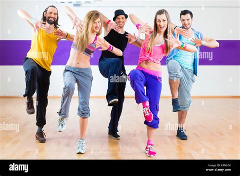 Group of men and women dancing zumba fitness choreography in dance school Stock Photo - Alamy