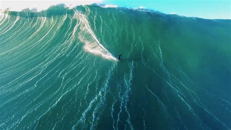 Drone video of surfer riding giant wave in Nazaré, Portugal - DroneDJ