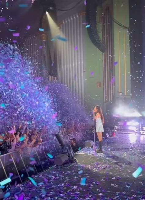 a woman standing on top of a stage surrounded by confetti