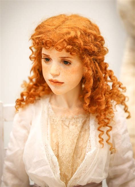 a close up of a doll with red hair
