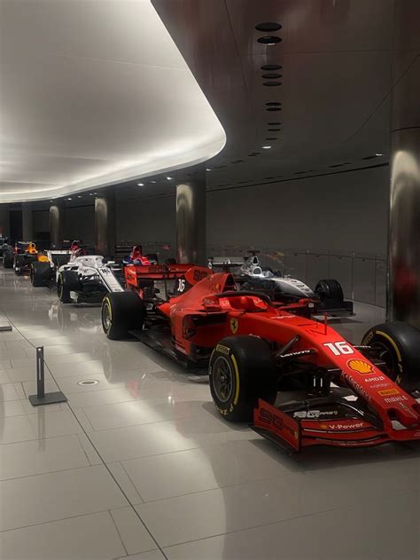 a row of race cars parked in an indoor area with white tile flooring ...