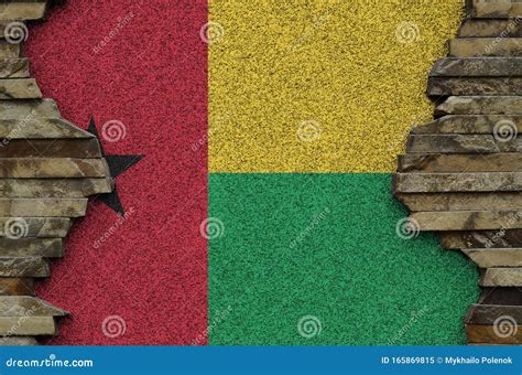 Guinea Bissau Flag Depicted in Paint Colors on Old Stone Wall Closeup ...