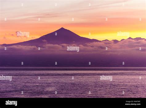 sunrise over mt teide, tenerife from the sea with low clouds Stock Photo - Alamy