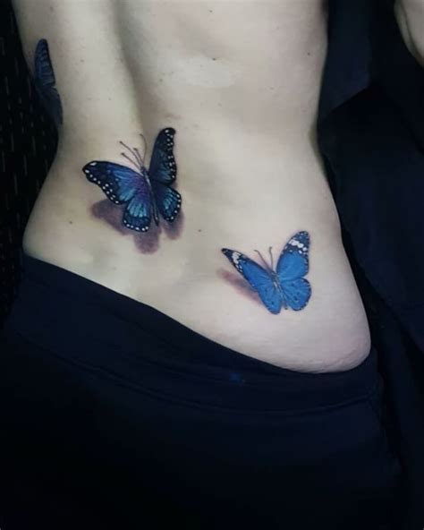 two blue butterflies on the side of a woman's stomach