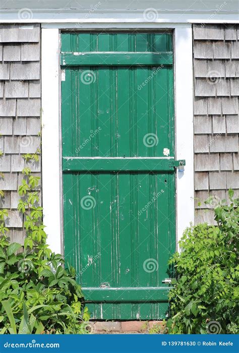 Weathered and Green Painted Wooden Door on a Gray House with Shingles Stock Photo - Image of ...