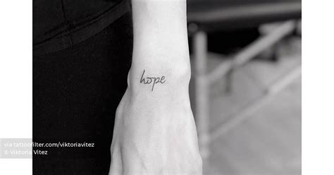 "Hope" lettering tattoo on the wrist.