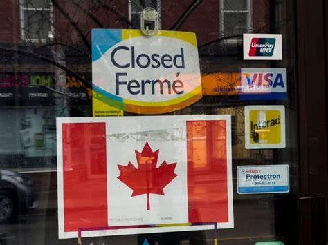 a close up of a store front window with signs on the glass and in the door