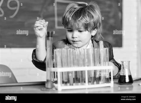 Little boy is making science experiments. school kid scientist studying ...