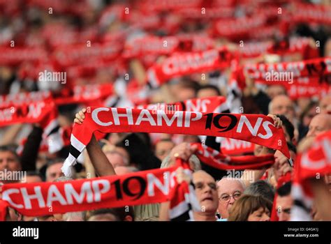 Manchester United fans wave champions scarves in the stands Stock Photo - Alamy