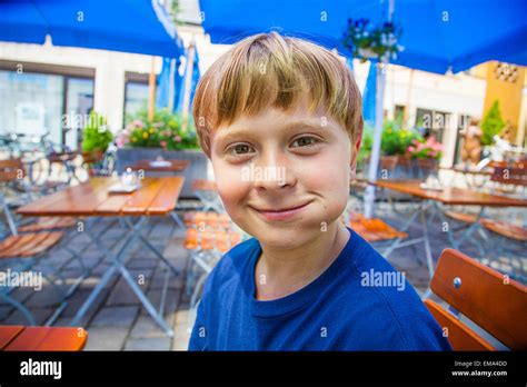 cute smiling child eats and has joy in the outdoor restaurant Stock Photo - Alamy