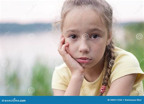 Sad Little Girl is Crying and Looking with Serious Face at Camera Stock ...