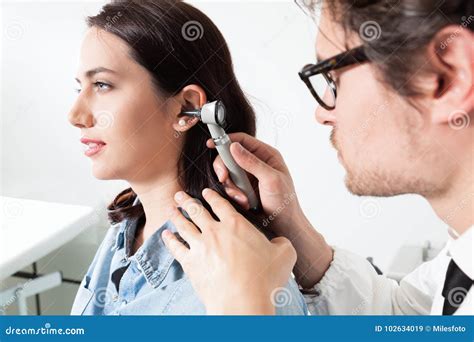 Doctor Holding Otoscope and Examining a Woman Patient Ear Stock Image - Image of exam, otologist ...