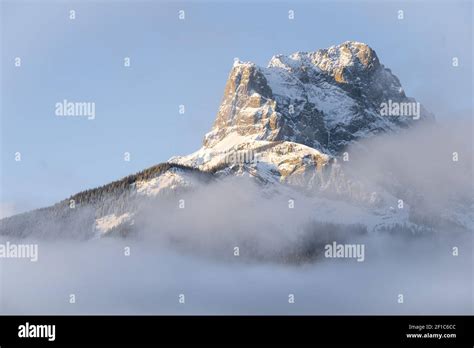 Mountain peak catching first sun rays during sunrise, shot at Three ...