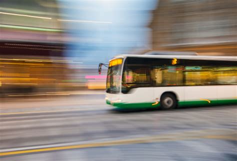 Bus Driving On City Street Stock Photo - Download Image Now - iStock