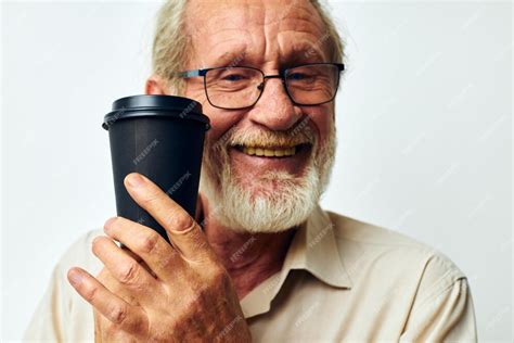 Premium Photo | Smiling man holding a glass of coffee on a light background