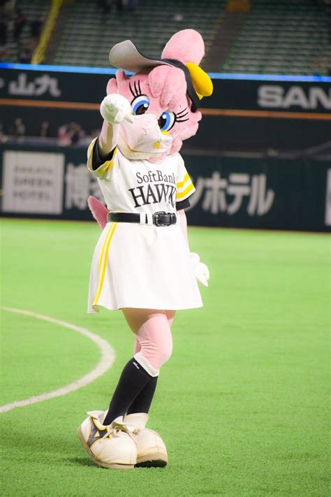 the mascot is wearing a white dress and black shoes while standing on a ...