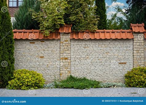 Modern Brick Pattern of Light Stone Fence Wall with Tiles in Front of a ...