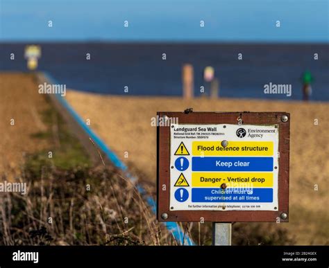 Environment Agency Flood Defence Structure Warning Sign at Landguard near Felixstowe Suffolk UK ...