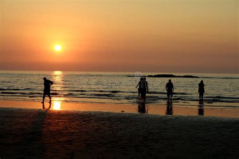 People on beach at sunset stock photo. Image of outside - 3831520