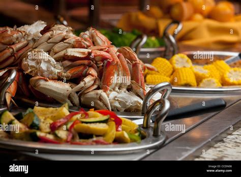 A classy buffet line at a resort's restaurant has crab legs as well as ...