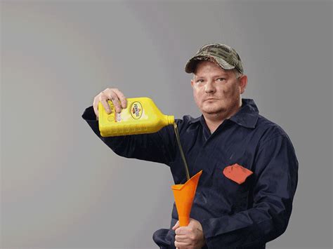 a man is pouring orange juice into an orange cup with a yellow straw in it