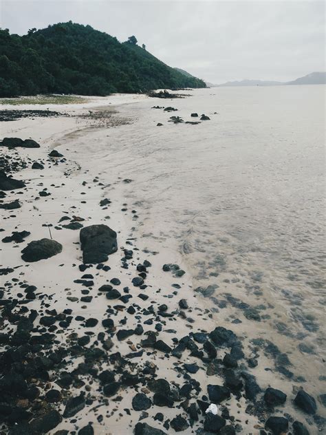 Photo Of Seashore With Rocks During Daylight · Free Stock Photo