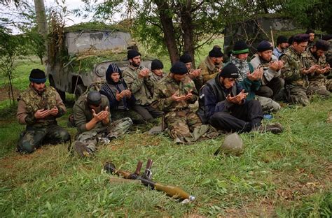 Chechen rebels praying before going off to the frontline to fight the ...