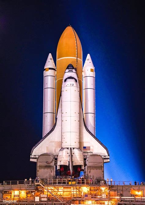 Space shuttle Atlantis, attached to its bright-orange external fuel tank and twin solid rocket ...