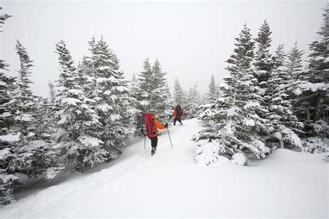 Two Men Hiking Through The Snow On Mt Photograph by Jose Azel