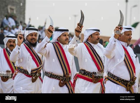 Traditional dressed local tribesmen dancing at the Al Janadriyah Festival, Riyadh, Saudi Arabia ...