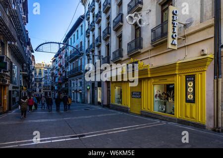 Typical colorful street in Pamplona old town with the tower bell ...