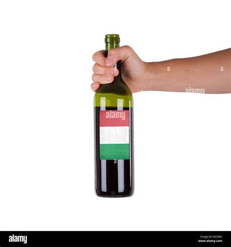 Hand holding a bottle of red wine label of Italy isolated on white Stock Photo - Alamy