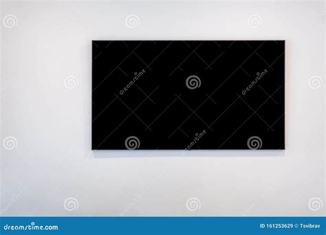 Black Flat Screen TV on White Wall. Stock Image - Image of isolated ...