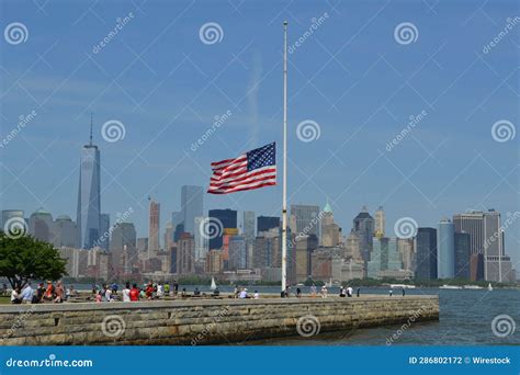 The American Flag Flies at Half Mast Overlooking a City Skyline ...