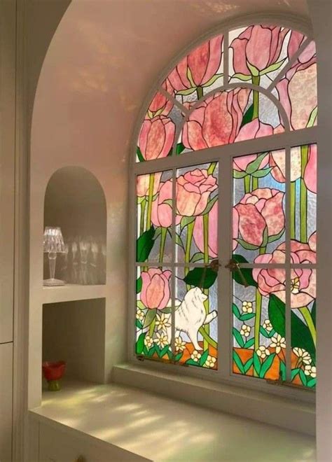 an arched window with pink flowers on it