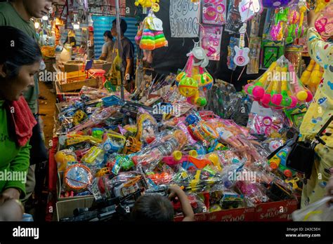 Asian people are looking at plastic toys made in China at a trade show ...