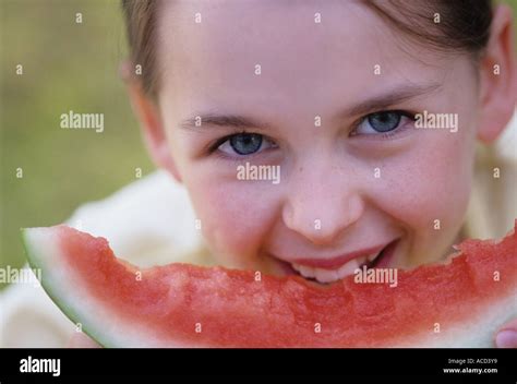 Nine year old girl at picnic table eating watermelon MR Stock Photo - Alamy