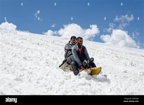 Tourist enjoying sledge ride at Gulmarg Gondola Phase 2 / Apharwat Peak ...