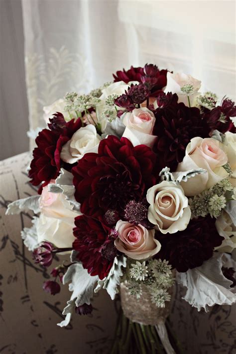 Stunning burgundy, blush and champagne wedding bouquet. Burgundy dahlias, blush roses, cream ro ...