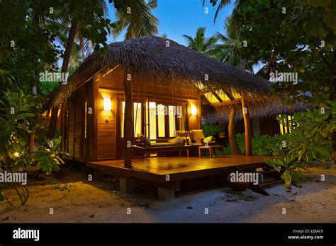 Beach bungalow at sunset - Maldives Stock Photo - Alamy