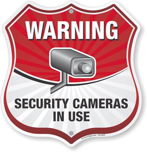 Warning Security Cameras in Use Sign, Shield Shape, SKU: K2-5015