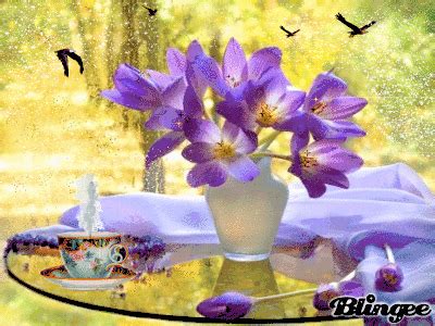 purple flowers in a white vase on a table with birds flying over it and ...