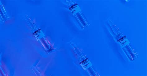 Coronavirus vaccine in similar sealed vial in blue lab · Free Stock Photo