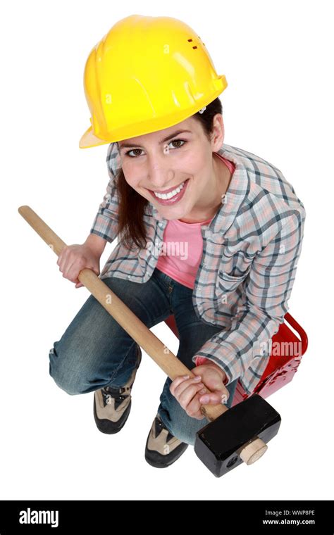 Woman with sledge-hammer sitting on tool box Stock Photo - Alamy