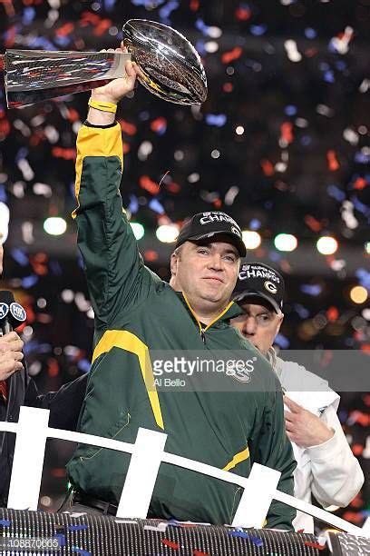 Head coach Mike McCarthy of the Green Bay Packers holds up the Vince...