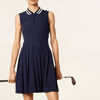 a woman in a dress holding a golf club