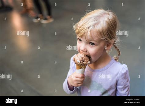 child eating ice cream cone in marketplace Stock Photo - Alamy