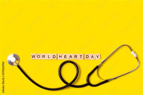 world heart day text with stethoscope on yellow background, health insurance concept, world ...