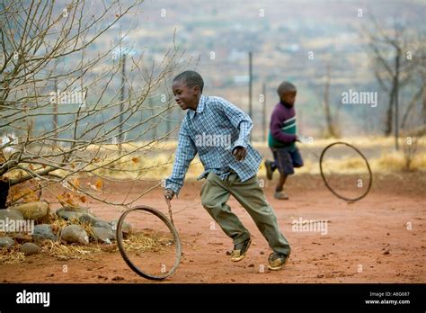 Young South African children play with wheel rims Stock Photo: 2229894 ...